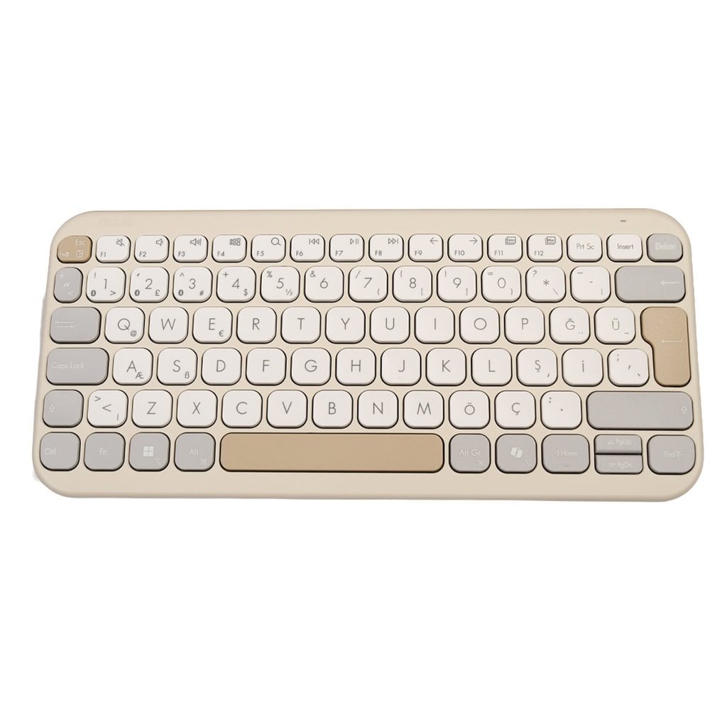 Pembe ve bej tonlarda kompakt ofis klavyesi, WERT ve QWERTY düzenli tuşlar, sade tasarım ve taşınabilir boyutlarla masaüstünü tamamlar.
